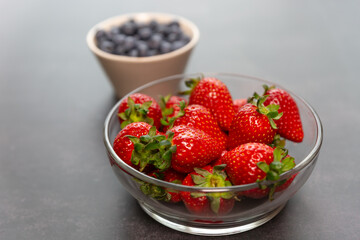 Red ripe strawberry background, close-up, front view, top view, strawberry plate with black background,