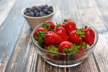 Red ripe strawberry background, close-up, front view, top view, strawberry plate with wood floor background,