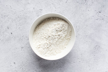 Bread flour in a white bowl, baking flour in a bowl