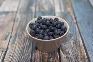 Blueberries isolated on wood table background, close-up, front view, top view,