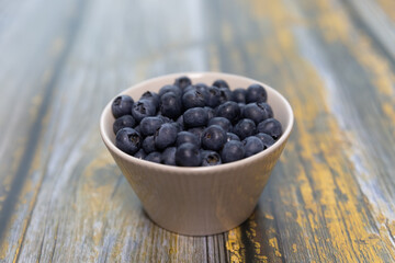 Blueberries isolated on wood table background, close-up, front view, top view,