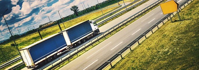 Approaching Destination: Panning Side View of White Truck Driving on Road, Heading Towards...