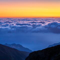 sunrise over the clouds, with the ocean below