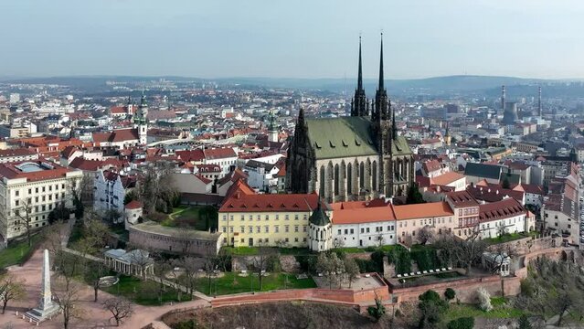 Brno, Czechia. Roman Catholic cathedral. Originally medieval in gothic style, many renovations, High towers added in Gothic revival between 1901-1909. Aerial view. Spilberk castle in the background