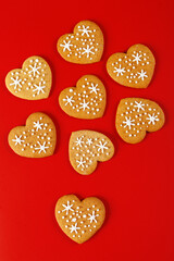 beautiful hand-baked cookies in the shape of a heart on a red background - obrazy, fototapety, plakaty