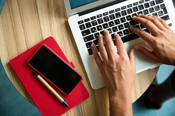 Cropped picture of male hands typing on laptop