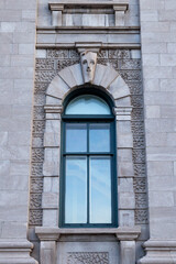 Arched window of the historic circa 1860 smooth cut stone Customs House at 130 Dalhousie Street in the old port area, Quebec City, Quebec, Canada - obrazy, fototapety, plakaty