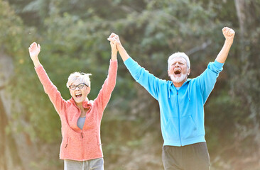senior fitness woman man active sport exercise together running jogging hand celebrate celebration happy raised arm success victory team achievement teamwork winner up winning freedom healthy fit