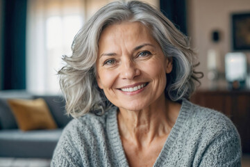American elderly woman with gray hair is smiling and looking at the camera