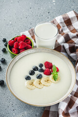 sweet semolina with berries on a light stone background