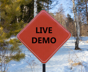 Live demo symbol. Concept words Live demo on beautiful red road sign. Beautiful forest snow blue...