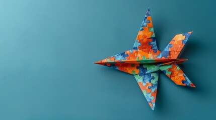 A paper plane in origami style with a puzzle ribbon to raise awareness for autism day or month.