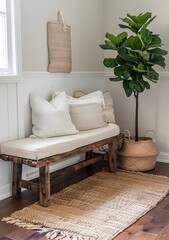 A cozy corner in the entryway of an apartment with a wooden bench, beige pillow and a white basket filled with plush pillows