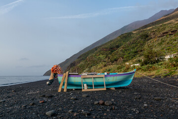fishing boat in volcanic landscape on the island of Stromboli
