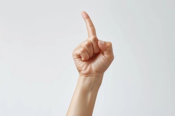A person's hand with a finger up in the air. Suitable for various concepts and ideas