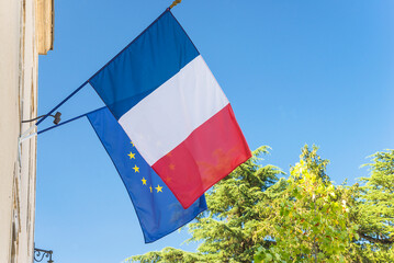 Flags of France republic and european union against the blue sky
