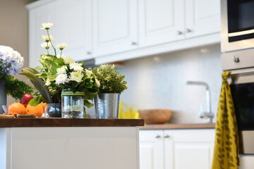 the shot of the bouquet and flowers in the modern design kitchen

