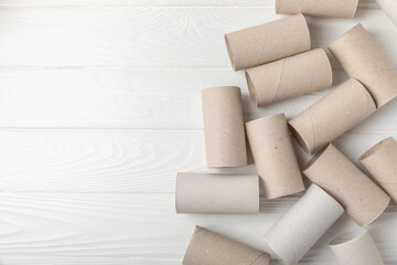 Empty toilet paper roll. Rolls of toilet paper on background. Paper tube of toilet paper. Place for text. Copy space. Flat lay. Eco-friendly reuse recycle