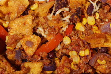 Close up nachos with vegetable curry, corn, onions, peppers, beans, vegetarian minced meat. May,...