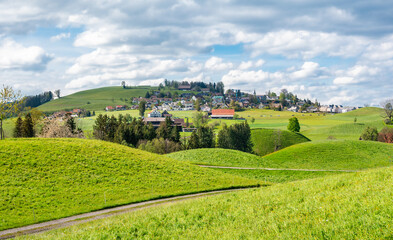 Naklejka premium Drumlin hill landscape and a village of Hirzel , Switzerland, in summer