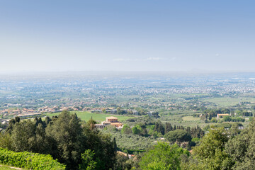 Picturesque panoramic view from the top of the valley in which the suburbs of Rome are located, sunny day, blue sky, distant horizon