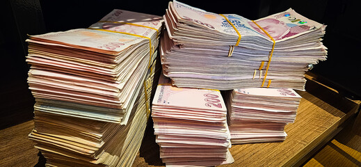 Bales of Turkish Lira banknotes in the bank in front of the cash register