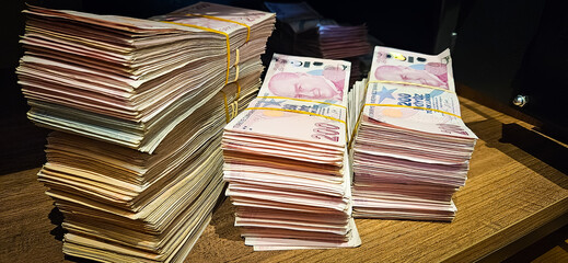Bales of Turkish Lira banknotes in the bank in front of the cash register
