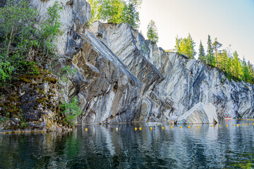 marble canyon with marble rocks and mountains in the mountain park of Karelia in Russia with a pond, green fir trees, trees and park - Powered by Adobe