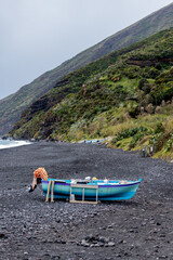fishing boat in volcanic landscape on the island of Stromboli