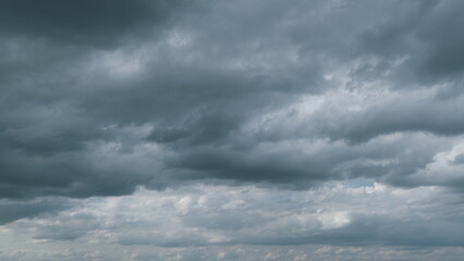 Dark blue sky with clouds. Fluffy white clouds to dark rain clouds. Moving and changing cloudscape...