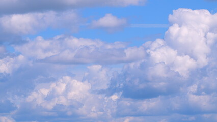 Dramatic moving white cumulus and cirrocumulus clouds or puffy fluffy cloudscape on beautiful sunny blue sky. Time lapse.