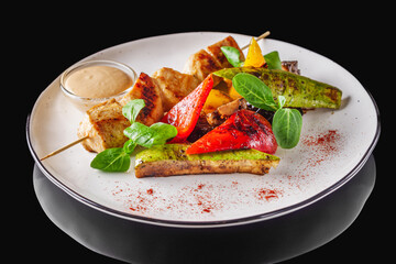 barbecue chicken and vegetables on a white plate