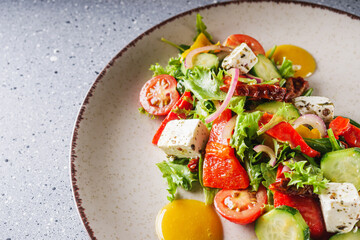 salad with baked bell peppers tomatoes cucumber red onion and feta cheese