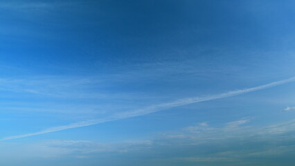 Summer sky. Cirrus clouds on bright blue sky. Wispy cirrus clouds pass over blue sky in nature....
