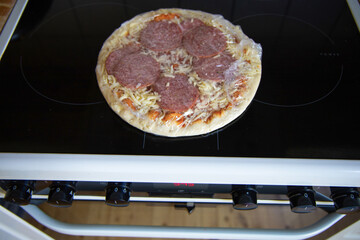 Frozen semi-finished pizza from the supermarket. Fast food concent