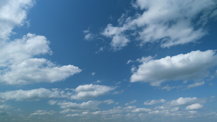 Blue sky cumulus and stratocumulus clouds. Scenic aerial background of blue sky with cumulus...