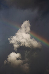 Arco-Íris entre nuvens, com um céu nublado (modo retrato)