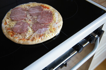 Frozen semi-finished pizza from the supermarket. Fast food concent - obrazy, fototapety, plakaty