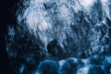 Wave textures underwater in blue sea. Swell in ocean, crashing waves