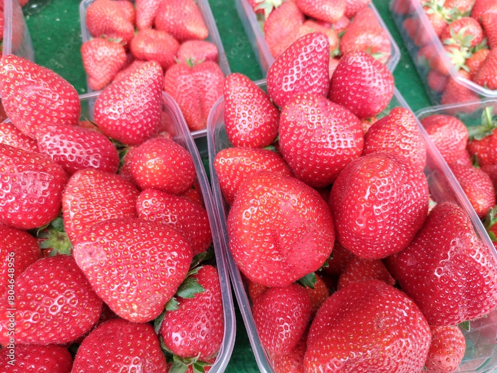 Wall mural heaped up bowls full of strawberries lined up for sale. fresh fruit, organic, bright red color, nutr