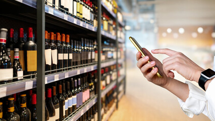  Selling wine online. Internet ordering of wine and alcohol product. Businessperson using...