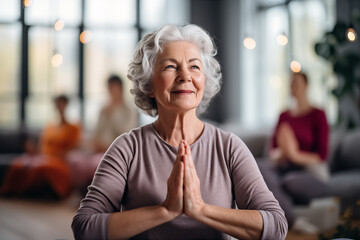 elderly womans with grey hair is practicing yoga, background with selective focus ,copy space