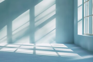Obraz premium Room with numerous windows, casting shadows on light blue walls. Minimalist design with natural light streaming in