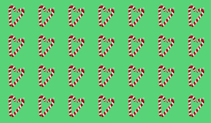 Repeated pattern of heart-shaped candy canes on a vibrant green background.
