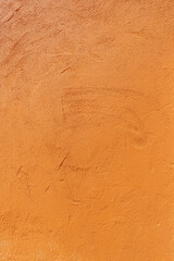 Texture of an old orange plastered wall. Abstract construction background.