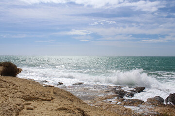 natural background of sky, sea and rocks, Mediterranean coast in Spain, waves on the beach