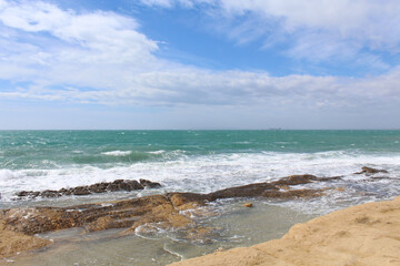 waves on the beach, natural background of sky, sea and rocks, Mediterranean coast in Spain 