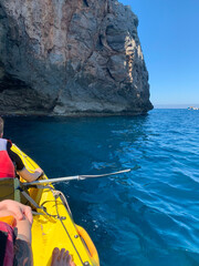 two happy children in kayak back view, tourists kayaking on sea on sunny day, boys 10 years old in...
