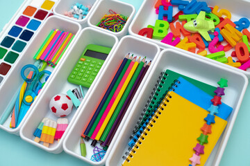 School supplies.Concept back to school. colored stationery is arranged in white organizers....