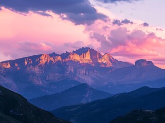 Beautiful mountain range at sunrise with pink and purple sky
